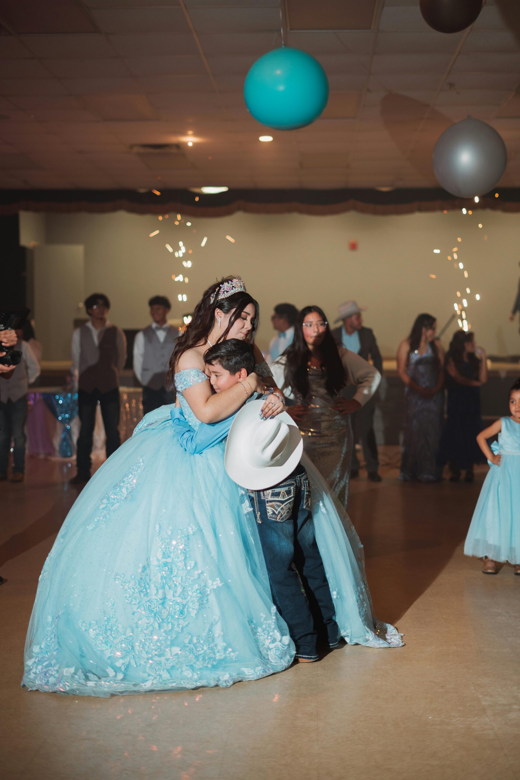 A joyous moment at a quinceañera with a young girl and family celebrating in style.